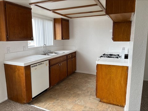 a kitchen with a stove top oven next to a sink